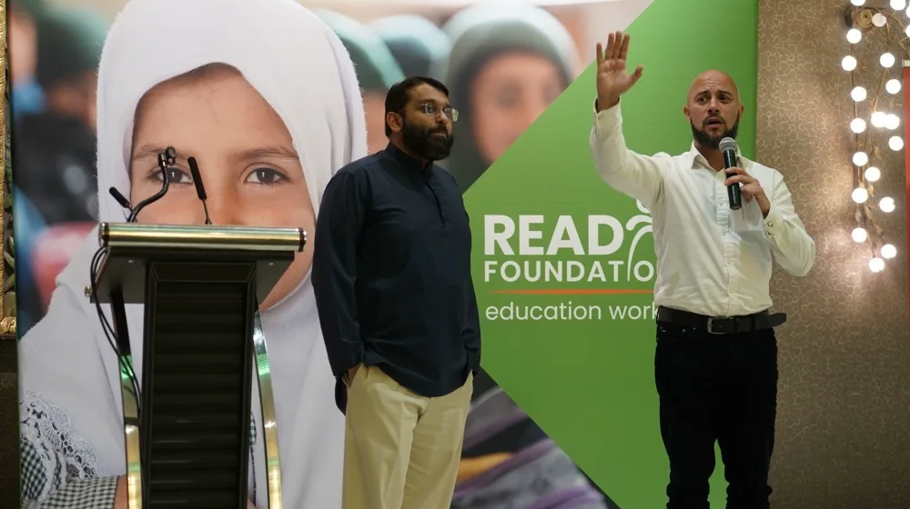 Shaykh Yasir Qadhi on stage at a READ Foundation event