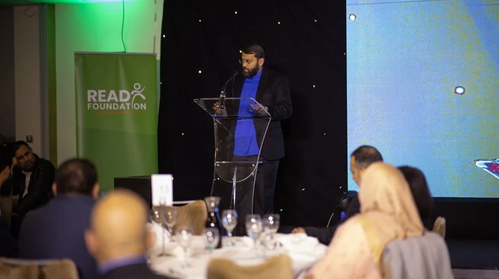 Shaykh Yasir Qadhi speaking at the podium at a READ Foundation fundraiser