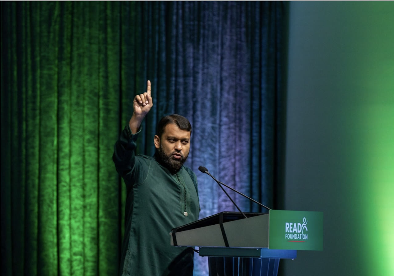 Shaykh Yasir Qadhi speaking at the podium during a READ Foundation event