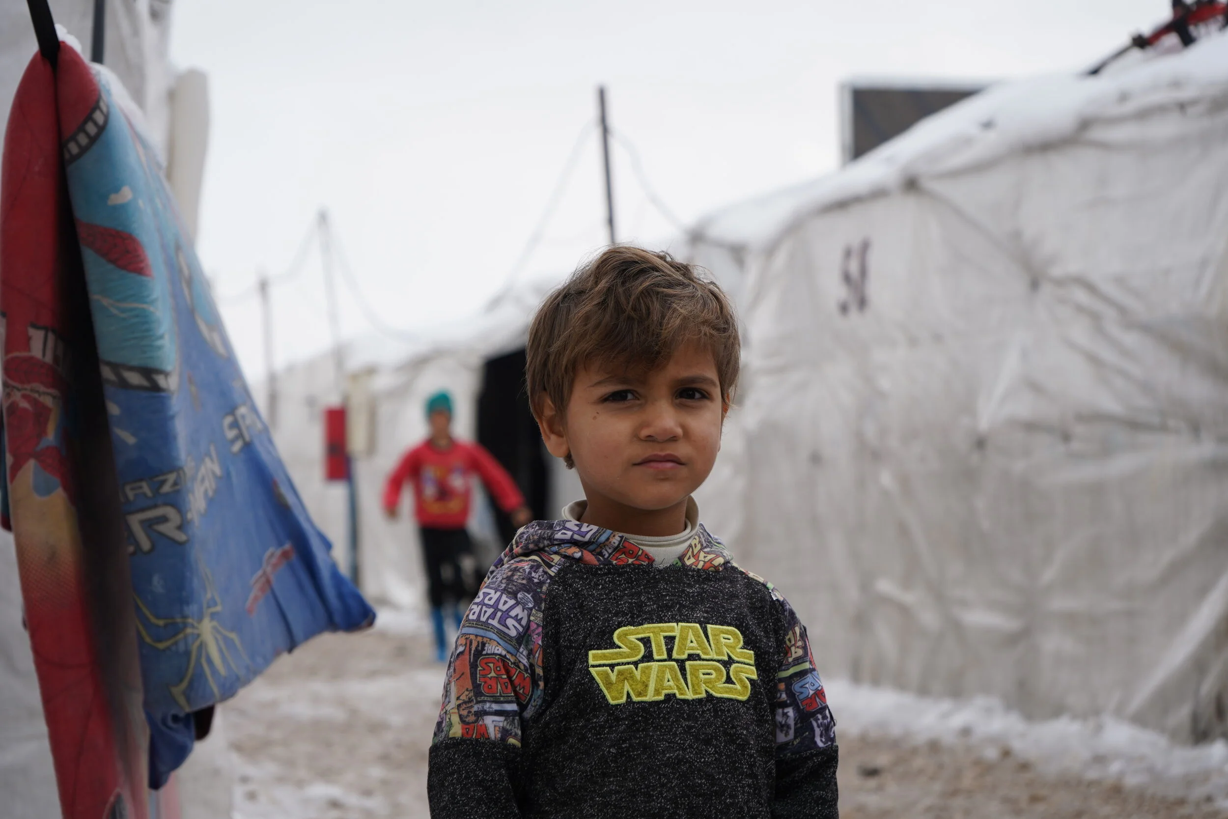 Child in warzone refugee camp